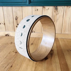 cork yoga wheel with moon phase design in studio setting