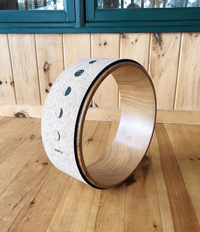 cork yoga wheel with moon phase design in studio setting