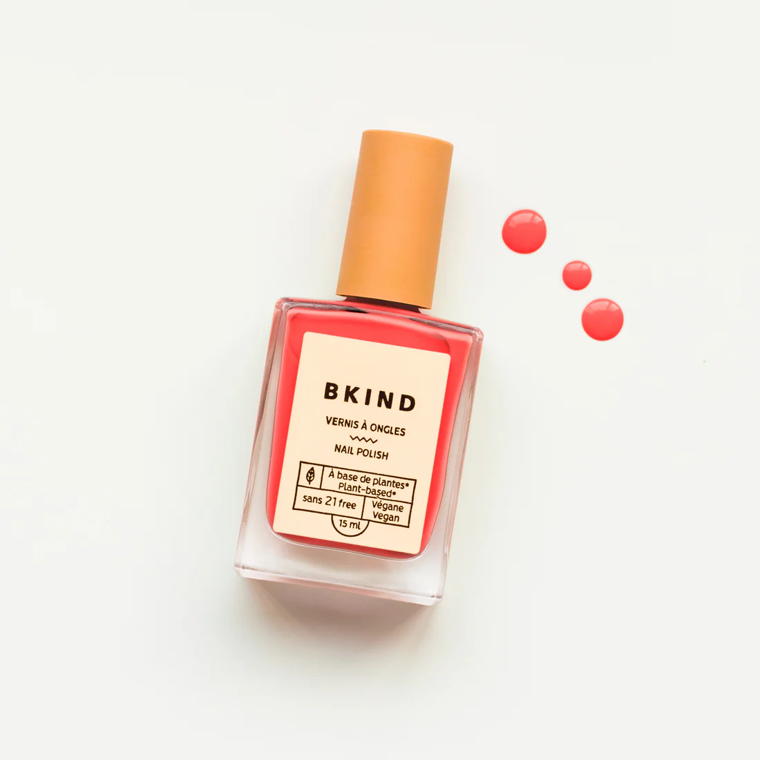 coral crush nail polish is a bright pink colour displayed in a square nail polish container against a white background