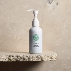 Fresh face daily cleanser pump bottle against plain backdrop