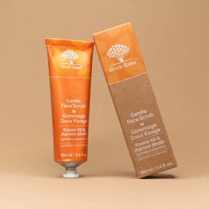 gentle face scrub by birch babe packaging against orange backdrop