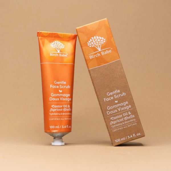 gentle face scrub by birch babe packaging against orange backdrop
