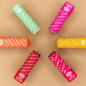 lip and cheek tint from birch babe laid out in pinwheel display against brown background