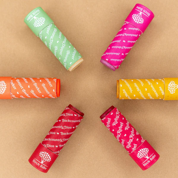 lip and cheek tint from birch babe laid out in pinwheel display against brown background