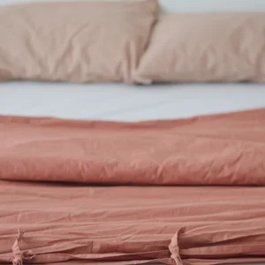 Cinnamon colour duvet cover laid on bed with white sheets