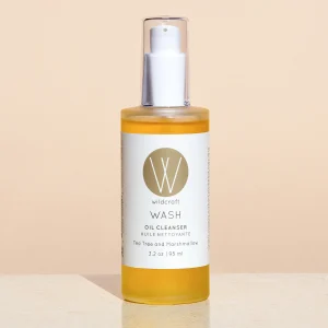 wash oil cleanser by Wildcraft product image against pink backdrop