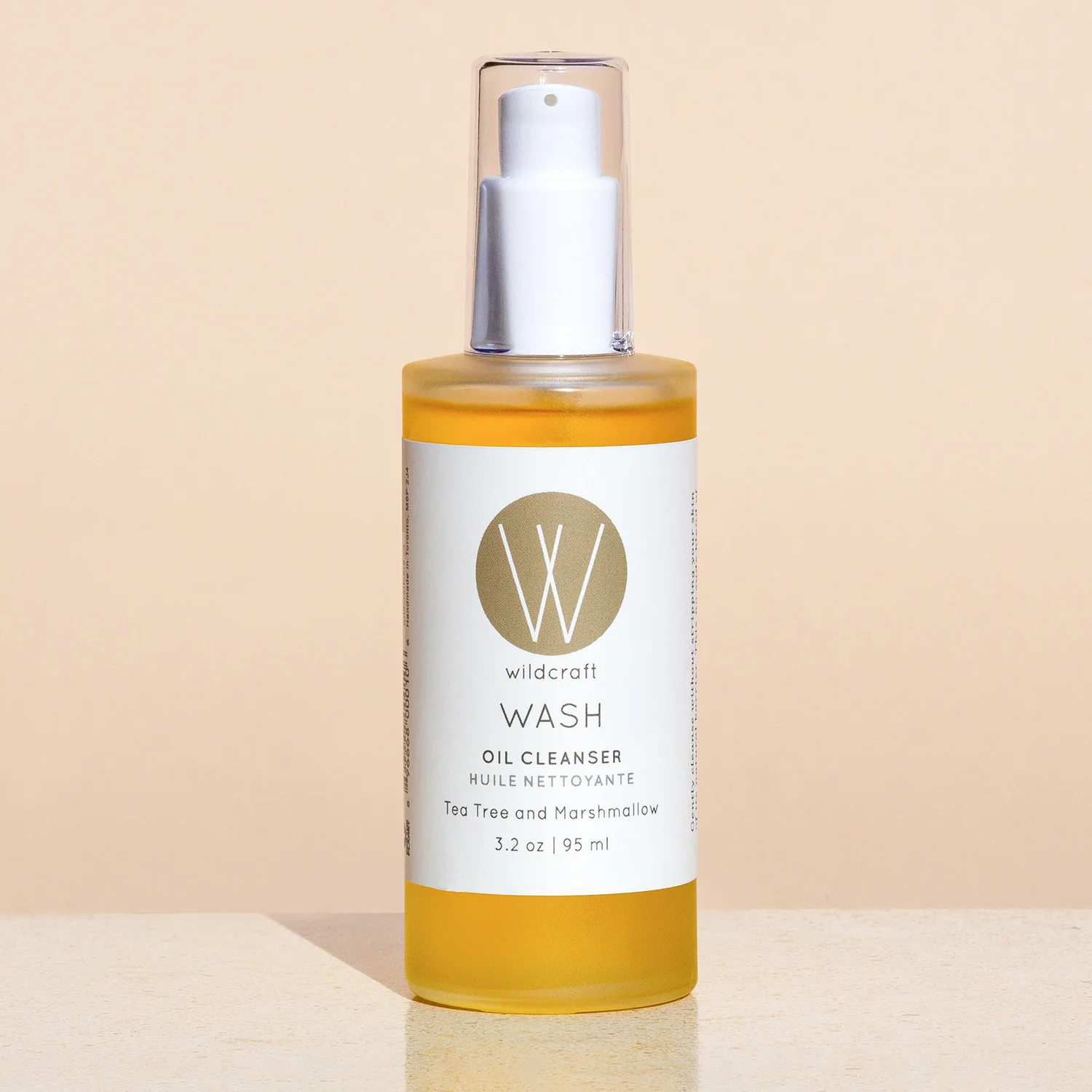 wash oil cleanser by Wildcraft product image against pink backdrop