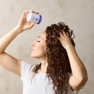 Dry shampoo being used by model in hair